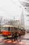 Women cross the road behind a tram