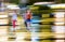 Women cross the street by night in blurred motion