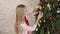 women decorate bell ornament on christmas tree, lifestyle of couple romance lover happy merry christmas holiday with tree before n