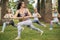 Women doing the warrior yoga pose outdoors at hotel garden area