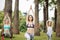 Women doing the warrior yoga pose outdoors at hotel garden area