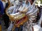 women in dragon costumes made of recycled plastic celebrate the cultural tradition of warak ngendog welcoming of Ramadan