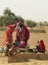 Women draw water form the well and take it to their home