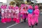 Women dressed in comedic pink costumes at breast cancer awareness event