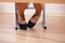 Women dressed in shoes under the table