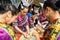 Women dressed traditional costumes preparing pastels and sweets