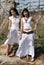 Women dressed in white in a wasteland of abandoned crops