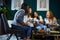 Women drink coffee laughing at a meeting of friends at home.