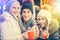 Women drinking mulled wine in mugs on German Christmas Market