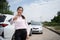 Women drivers stand in front of cars after accident and not worry because have car accident insurance. Online car accident