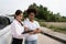 Women drivers Talk to Insurance Agent for examining damaged car and customer checks on the report claim form after an accident.