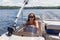 Women driving a pontoon boat on a lake