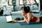 Women and ear phone listen music between workout and relaxing. Laptop, apple, dumbbell and water bottle on the ground beside