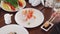 Women eating sushi with chopsticks at restaurant