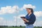 Women engineer using tablet for working on site at wind turbine farm