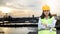 Women Engineering wearing hard hat and working at construction site