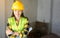Women Engineering wearing yellow helmet at construction site