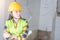 Women Engineering wearing yellow helmet and working at construction site