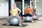 Women exercising with ball during group pilates class