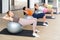 Women exercising with ball during group pilates class