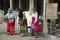Women fasten their borrowed sarongs before entering a Thai temple