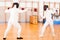 Women fencers in duel at fencing sparring