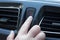 Women finger hitting car emergency red light button in car.