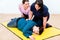 Women in first aid class training to position injured person