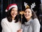 Women friends, Christmas and sparkle stick with smile, home and celebration of festive holiday. Girl, woman and