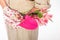 Women gardener tools pink colored bouquet flowers