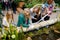 Women and girls exploring botanical garden pond