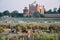 Women and goats walk by the Yamuna River behind the Taj Mahal, India.