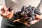 Women hand hold the brunch of the black grape, fresh grape harvest