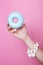 Women hand hold colorful donut