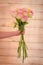 Women hand holding a bouquet of Esperance roses variety, studio shot.