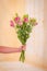 Women hand holding a bouquet of Pink Lisianthus Summer flower variety, studio shot, pink flowers