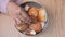 women hand pick baked bun on table