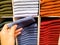 Women hand pick the dark blue sock from socks stack on shelves for sale in clothing store