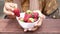 women hand pick Strawberries in a bowl