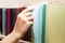 Women Hand selecting book from a bookshelf in