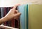 Women Hand selecting book from a bookshelf in library. Back to school.