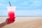 Women handle holding ice water italian soda red in plastic cup,Red