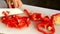 Women hands slicing sweet pepper in the kitchen