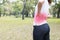 Women has waist pain and ache back as exercise in park