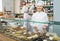 Women with hats selling nuts and pastry in shop