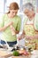 Women having fun in kitchen smiling