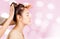 Women having head massage relaxation on pink bokeh background