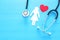 women healf Insurance . concept image of Stethoscope and female figure on wooden table. top view.