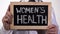 Women health written on blackboard in gynecologist hands, reproductive medicine