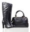 Women high-heeled boots and leather bag on white